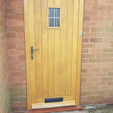 Arched timber cottage door with window